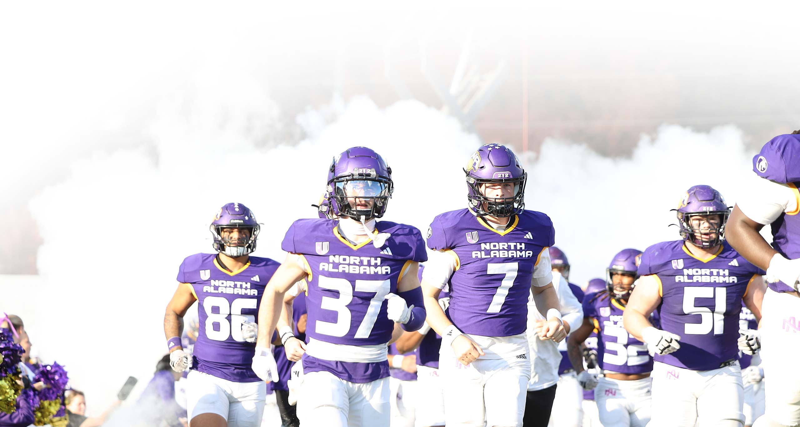 Football players running onto field